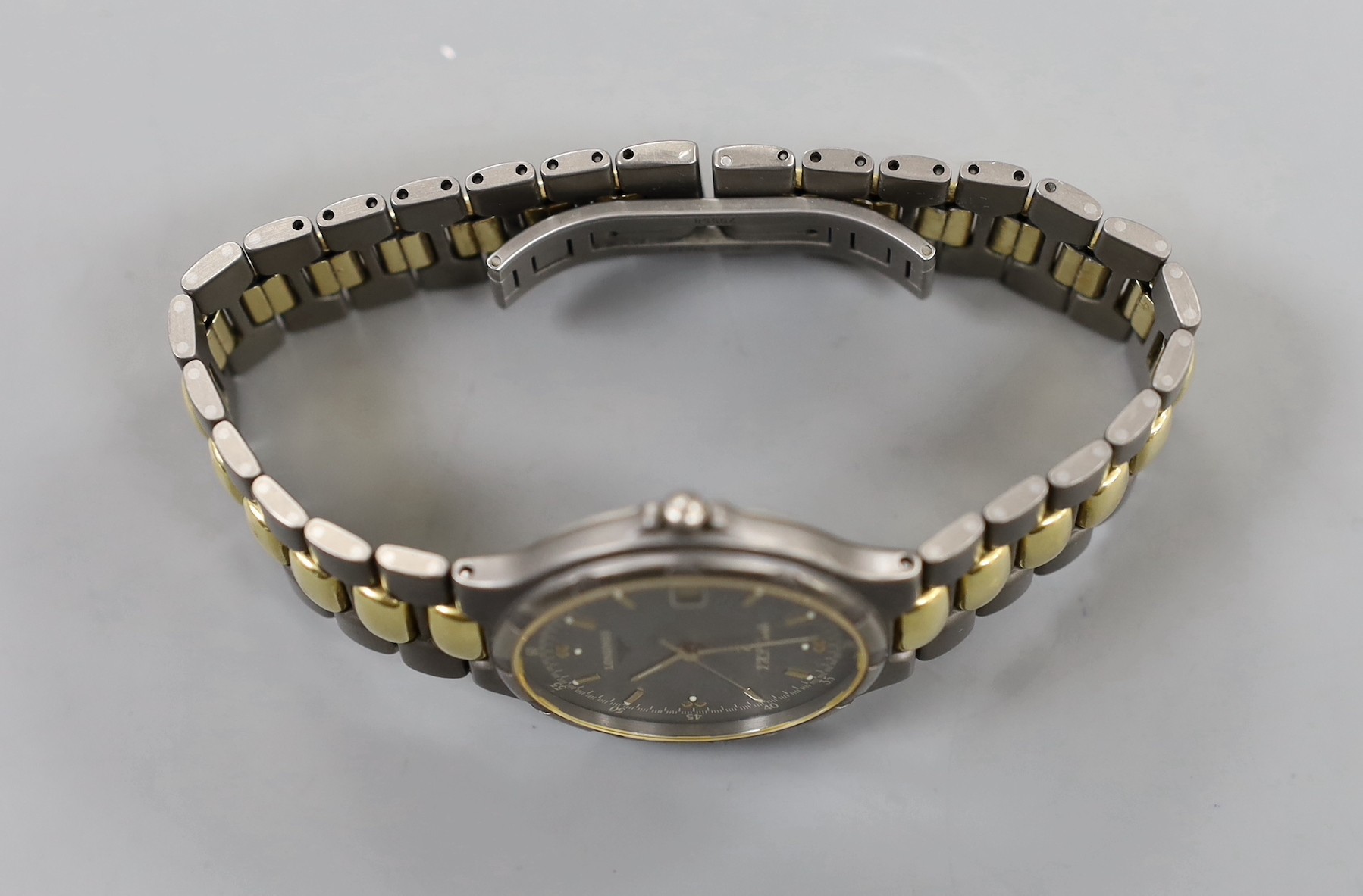 A gentleman's modern steel? and gold plated Longines TI VHP Quartz wristwatch, with box and some papers.